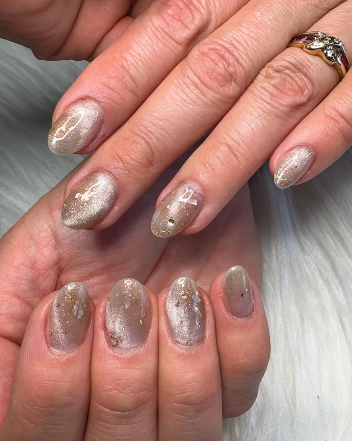Short oval nails with champagne shimmer and foil by Muskoka Nails & Spa