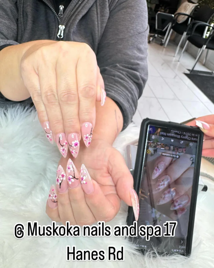 Pink almond nails with hand-painted flowering branches by Muskoka Nails & Spa