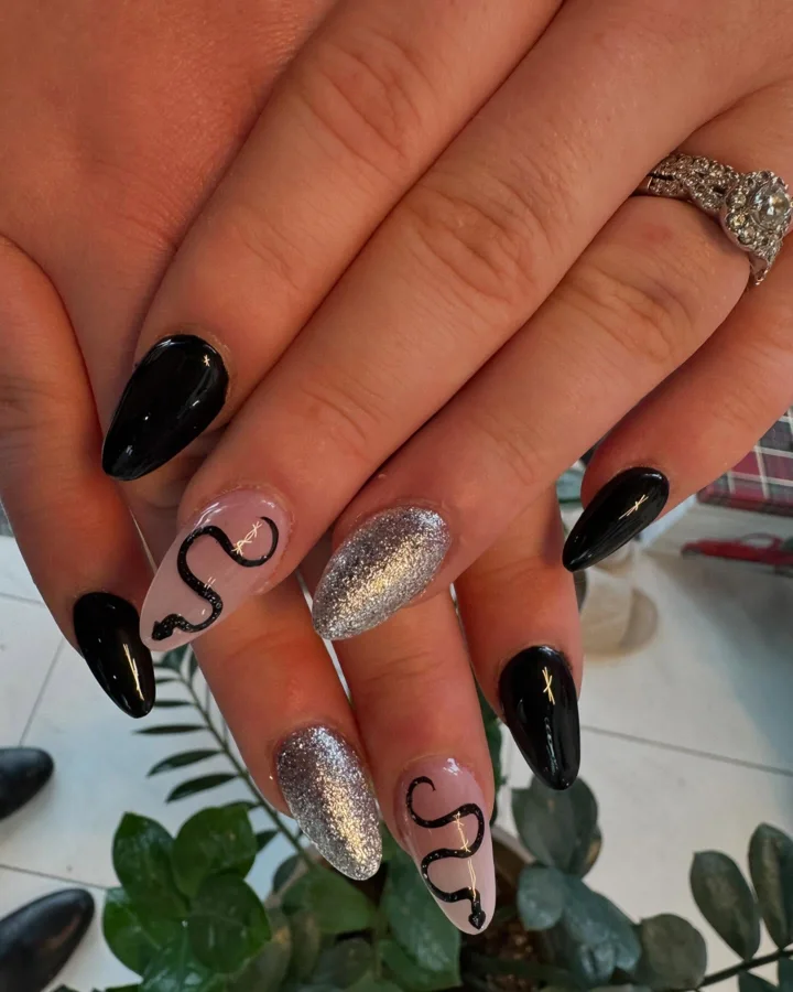 Black almond nails with silver glitter and snake designs by Muskoka Nails & Spa