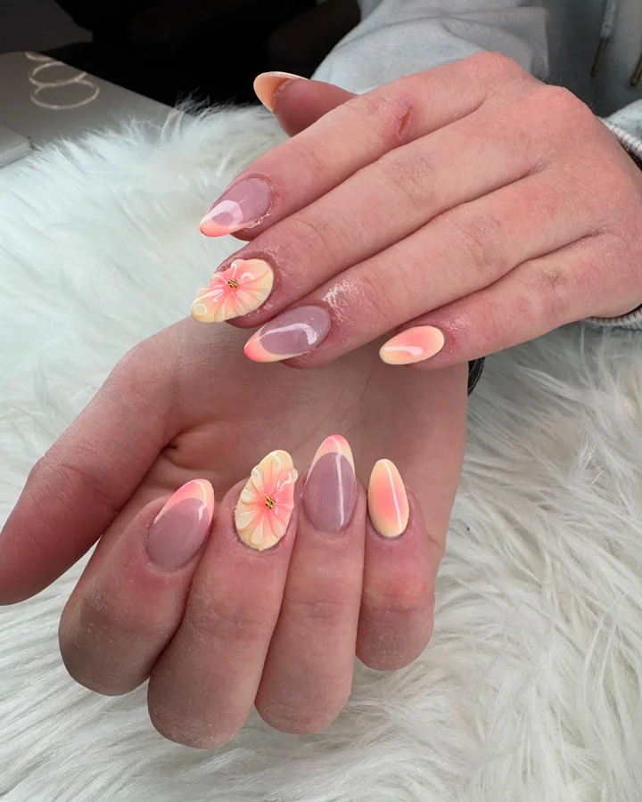 Peach and yellow French tips with sculpted flower accents by Muskoka Nails & Spa