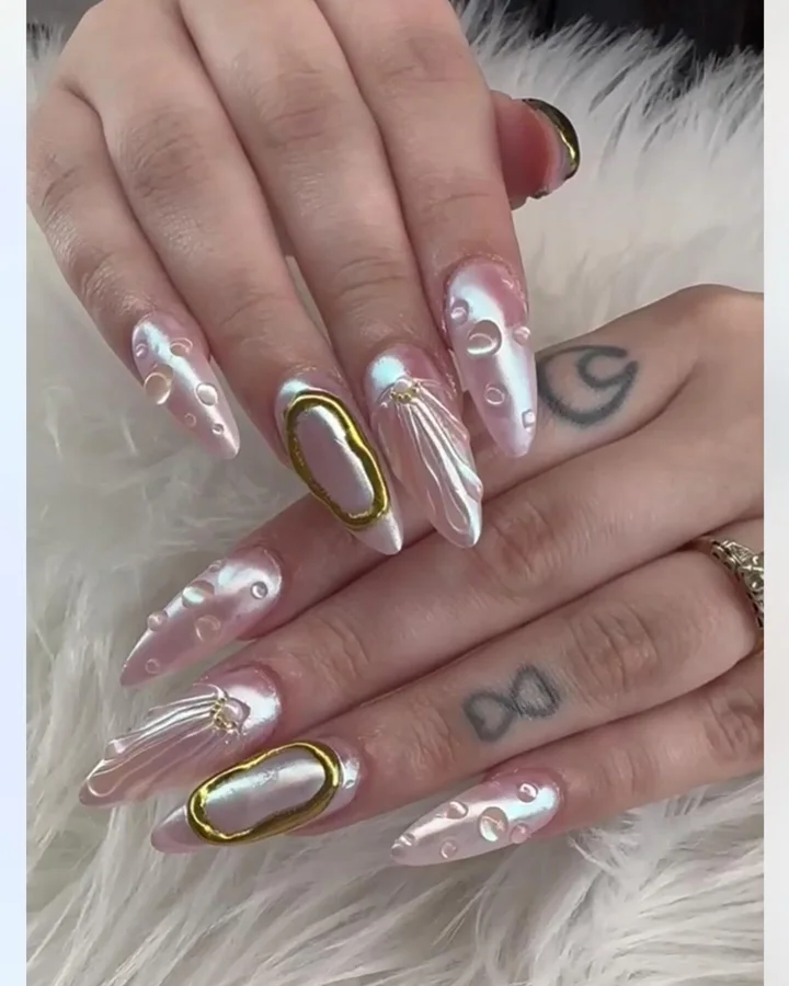 Pearlescent almond nails with gold and raised clear details by Muskoka Nails & Spa