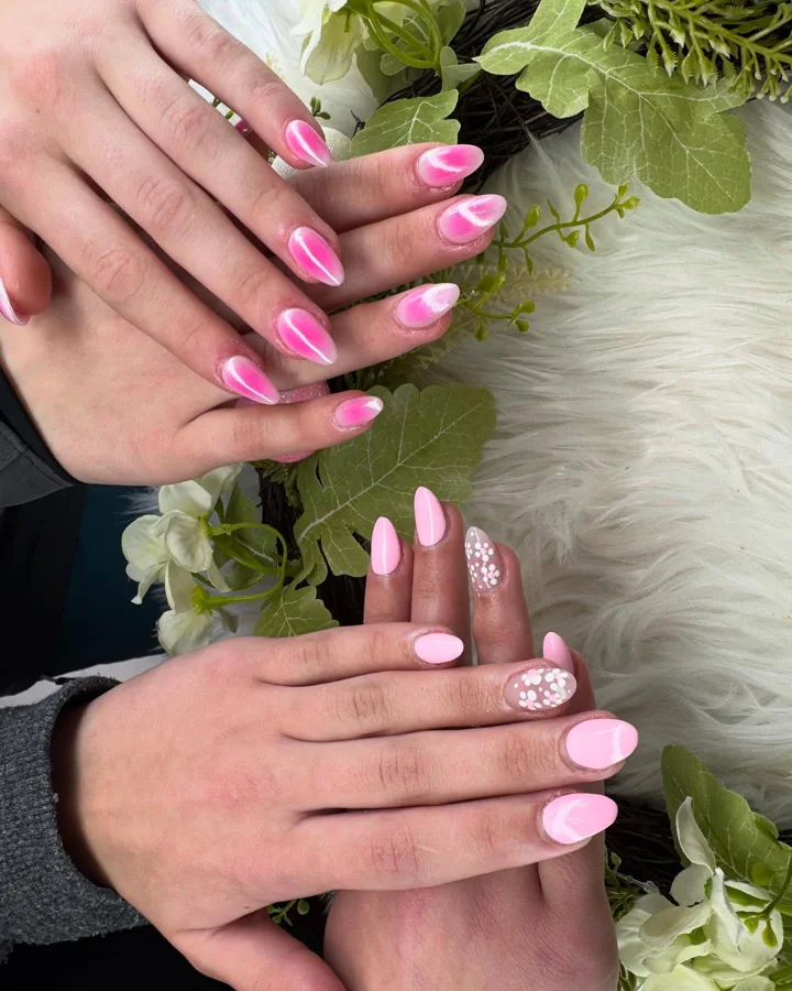 Pink almond nail designs with aura and white dot details by Muskoka Nails & Spa