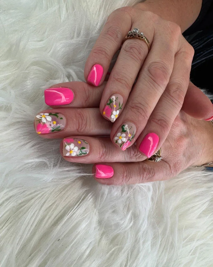 Hot pink nails with hand-painted daisies by Muskoka Nails & Spa
