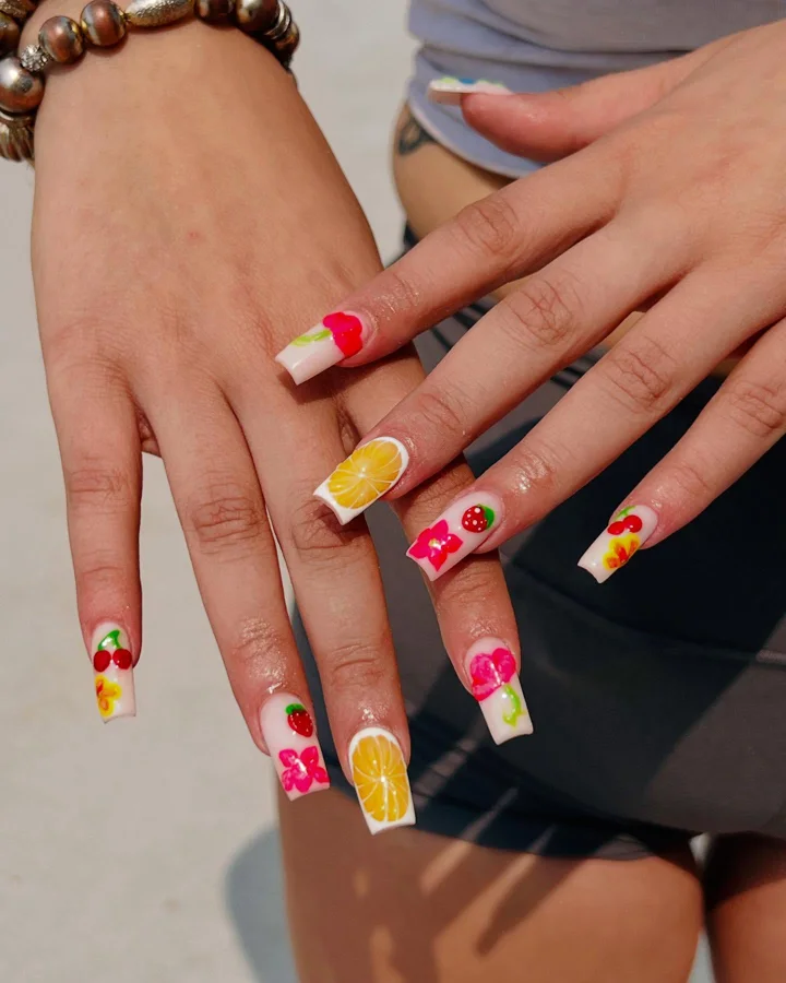 Square nails with colourful fruit and flower designs by Muskoka Nails & Spa
